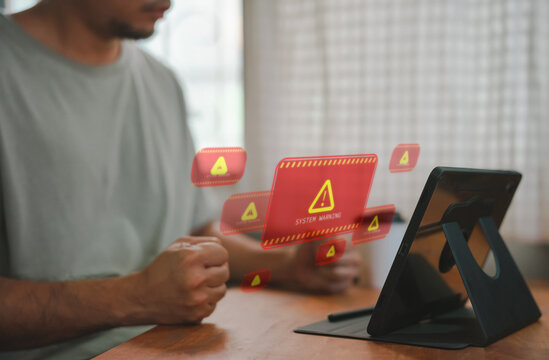 developer using computer laptop with triangle caution warning sign for notification error and maintenance concept. Computer virus detected, network security and maintenance concept.
