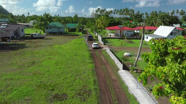 Teahupoo Tahiti French Polynesia aerial drone view end of the road neighborhood homes van car drive island coast to Papeete morning sunny bay channel coral reef valley river forward motion