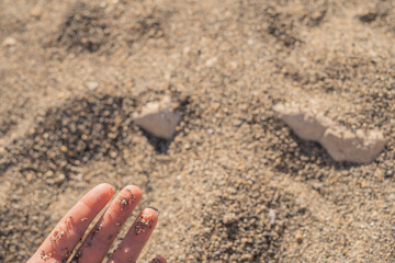 Fingers With Little Grains of Sand