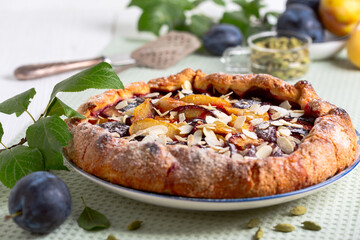 Open pie (galette) with plums and cardamom.