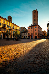 Old town square and medieval towers in Alba, italy.