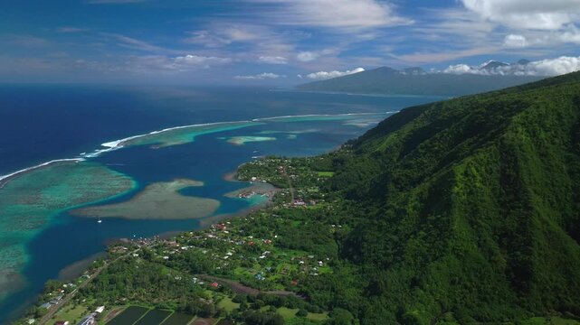 Coral reef break Teahupoo north south Tahiti islands French Polynesia aerial drone coast morning sunny channel Papeete Paris Olympics 2024 surf surfer surfer venue judge tower forward pan up motion