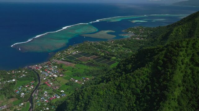 Coral reef break Teahupoo coastline Tahiti islands French Polynesia aerial drone coast morning sunny channel Papeete Paris Olympics 2024 surf surfer surfer venue judge tower forward pan up motion