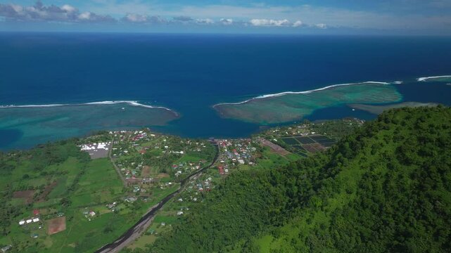 Teahupoo town Tahiti French Polynesia aerial drone Papeete mountainside coast morning sunny bluesky bay reef Paris Olympics 2024 surf surfer surfer venue new judge tower pedestrian bridge upward
