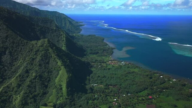Coral reef break Teahupoo down coastline Tahiti islands French Polynesia aerial drone coast morning sunny channel Papeete Paris Olympics 2024 surf surfer surfer venue judge tower forward pan up motion