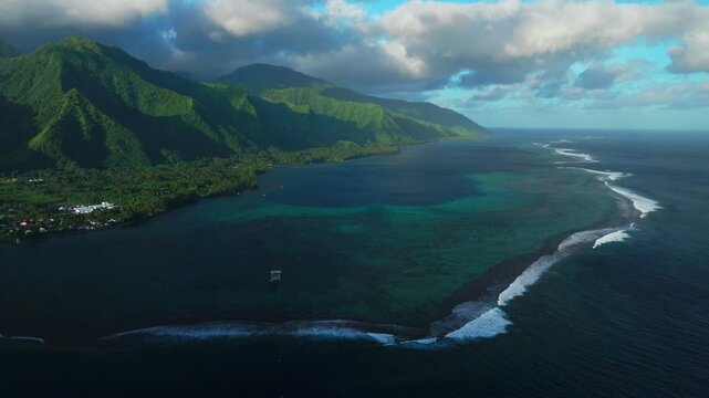 Perfect golden hour sunset towering mountain peaks surf reef break channel Teahupoo Wave Tahiti French Polynesia aerial drone view incredible island landscape Moorea Bora Bora Papeete circle right