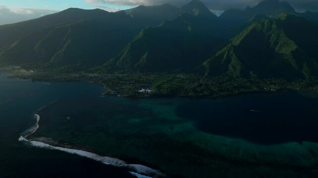 Last light sunset towering mountain peaks surf reef break channel Teahupoo Wave Tahiti French Polynesia aerial drone view incredible stunning island landscape Moorea Bora Bora Papeete forward pan up