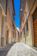 Travel Ideas. Summer Streets of Toledo City in Spain Alleyway Towards Toledo Cathedral Alcazar in The Afternoon.