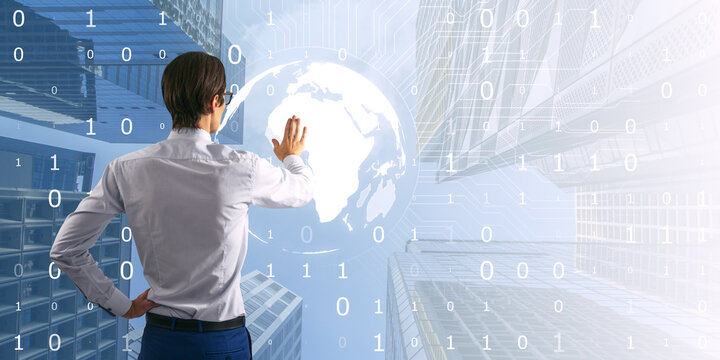 Attractive young european businessman using light digital globe on bright tech city background with mock up place. Double exposure.