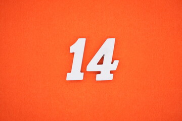 The numbers are made of white painted wood. Placed on the floor was orange paper.