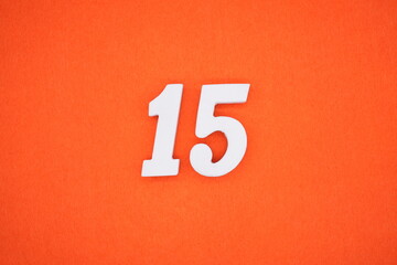 The numbers are made of white painted wood. Placed on the floor was orange paper.