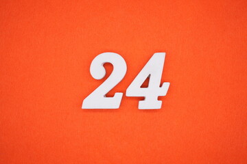 The numbers are made of white painted wood. Placed on the floor was orange paper.