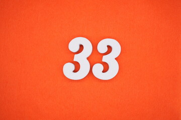 The numbers are made of white painted wood. Placed on the floor was orange paper.