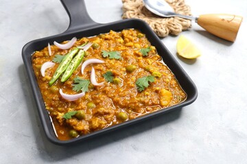 Indian famous dish Mutton matar Kheema Pav or Khima Paav is a minced goat meat curry. Mutton keema is cooked with onion, tomatoes, potatoes, and green peas along with Indian spices. copy sapce.