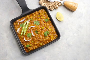 Indian famous dish Mutton matar Kheema Pav or Khima Paav is a minced goat meat curry. Mutton keema is cooked with onion, tomatoes, potatoes, and green peas along with Indian spices. copy sapce.