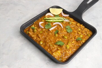 Indian famous dish Mutton matar Kheema Pav or Khima Paav is a minced goat meat curry. Mutton keema is cooked with onion, tomatoes, potatoes, and green peas along with Indian spices. copy sapce.