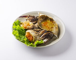 Close-up of Soy Sauce Marinated Crabs in pieces with lettuce on dish and white floor, South Korea
