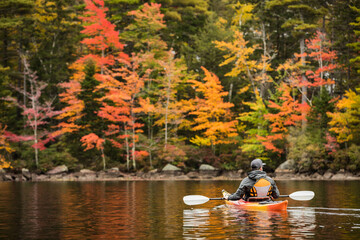 Kayaker on Island Pond Surrounded by Autumn Color