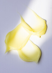 creamy smears cosmetic texture on a light background skin care concept sun glare