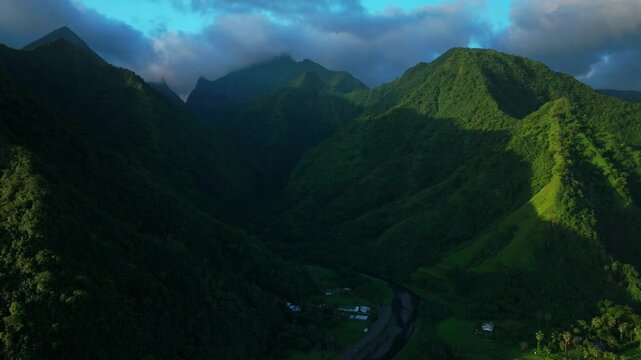 Sunset light towering mountain peaks valley town village Teahupoo  Tahiti French Polynesia aerial drone view incredible stunning island landscape Moorea Bora Bora Papeete circle right motion