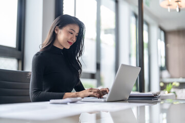 Beautiful confident asian business woman working with laptop Hands typing  keyboard. Professional investor working new start up project. business planning in office. Technology business