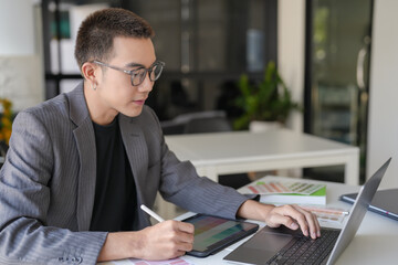 Business asian Man Artist Creative Designer sketch graphic drawing on graphic laptop and Color swatch samples Concept of idea creativity