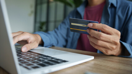 Businessman hold credit card online payment in laptop.