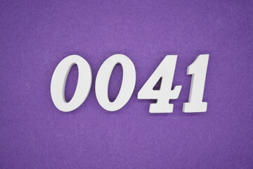The numbers are made of white paint wood, placed on the background as a purple paper.