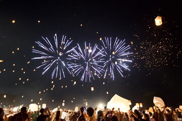 A Magical Night Sky with Dazzling Fireworks and Romantic Sky Lanterns