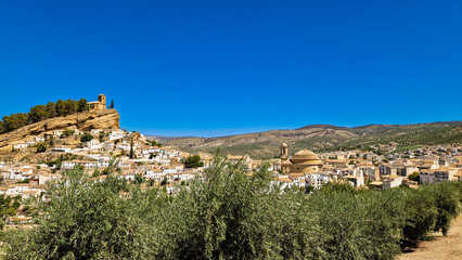 Obraz premium Un pueblo entre las montañas con un castillo a lo alto junto con un catedral con que formar una mirador de National Geographic 