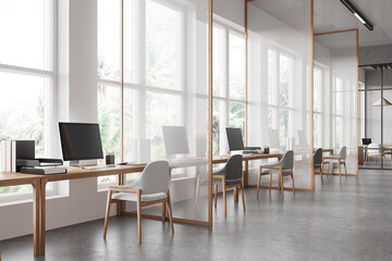 Office interior with pc computers and desks in row, dividers and window