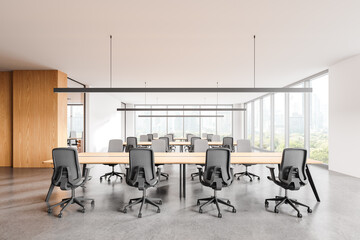 Office coworking interior with armchairs and desks in row, panoramic window