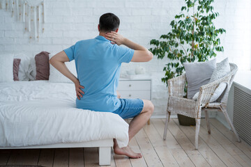 Lumbar and cervical spine hernia, man with back pain at home, compression injury of the...
