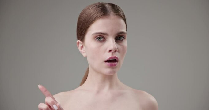 Beauty, health, cosmetics, anti-aging therapy and skin care concept - young beautiful brunette Caucasian woman looking at the camera, shaking her head expressing disagreement and showing no gesture