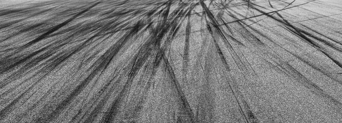 Asphalt race track with black tire mark texture and background, Abstract asphalt road race track background , Tire mark on race track texture and background. © Kalyakan