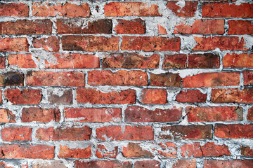 Close-up of a weathered red brick wall with visible mortar. Ideal for backgrounds, textures, and architectural designs. The aged and rustic appearance adds character and charm to any project.