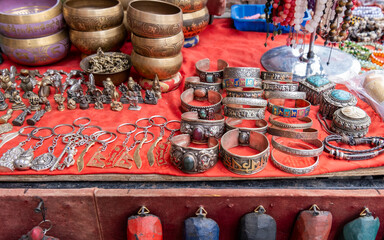 beautiful handcrafted tibetan silver bracelets, singing bowls and keychains sold at street gift store
