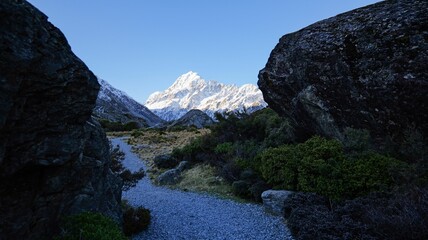 Scenic view of a mountain pathway leading to a snow-capped peak in New Zealand