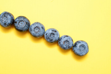 Fresh blueberry on yellow background