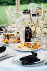 Luxurious restaurant. Luxurious interior, white tables, serving dishes and glasses for guests