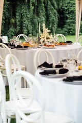 Luxurious restaurant. Luxurious interior, white tables, serving dishes and glasses for guests