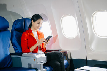 Asian Woman Working on Tablet During  in first class, multitasking with Flight Travel in style, work