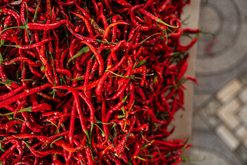 Fototapeta premium pile of Fresh Chilies and Ripe Red Chilies in Baskets for Sale at the Vegetable Market