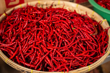 pile of Fresh Chilies and Ripe Red Chilies in Baskets for Sale at the Vegetable Market