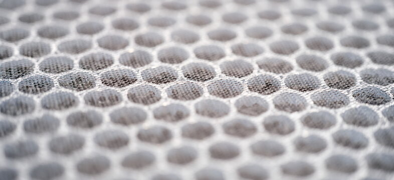 Close-up of multi-stage air filter with uv radiation and activated carbon granules. Replaceable carbon air purifier filter. Hepa filter surface background