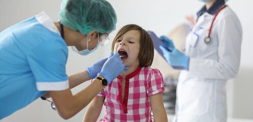 Close-up of female nurse, takes cotton bud to analyze saliva, nasal swab, mucous membrane for DNA...