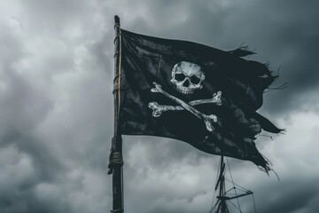 Pirate flag with skull and bones waving in the wind, cloudy sky background