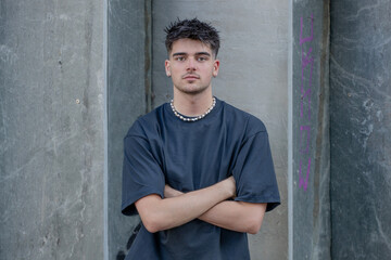 young man or teenager on the street serious looking at camera