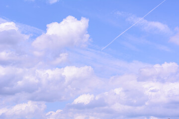 The blue sky with clouds on a sunny day. White clouds in the sky as background
