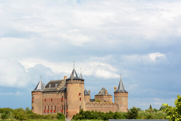 Medieval castle on the summer day. Dutch castle under the cloudy sky. Dutch architecture